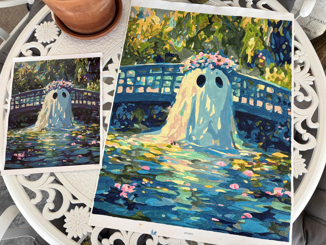 On the table is the completed Halloween paint-by-numbers, which is a picture of a ghost.
